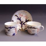 A English porcelain trio, tea cup, coffee can and saucer, bute shaped, decorated in the Imari style,