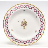 A Derby plate: `Gold anchor' mark - central sepia urn draped with polychrome flowers,