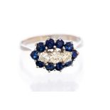 A diamond and blue sapphire boat shaped cluster 18ct whire gold ring,