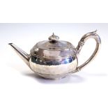 A George III silver teapot, shaped circular with C-scroll handle, tapering spout,