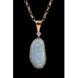 An 18ct yellow gold opal and diamond pendant, set with an asymetric opal approx 19mm x 9mm,