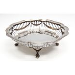 A George V silver shaped circular basket, reeded border above reticulated sides,