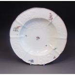 A Chelsea soup plate with moulded borders of flowers and leaves and Gotskowsky type painted with