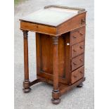An early Victorian rosewood Davenport, having four drawers to sides, slope front,