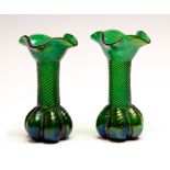 Attributed to Loetz, an early 20th Century pair of green iridescent glass vases, wavy rims,