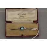 An Art Deco blue zircon and diamond set platinum and 18ct white gold bar brooch,