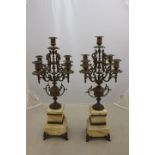 A pair of 19th Century French brass candelabras, the four scrolling branches on an urn support,