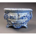 A 19th Century Delft novely model of a miniature commode, decorated with scrolls, lovers and boats,