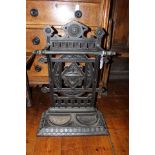 A Victorian cast iron Aesthetic Movement stick stand, cast with flowers, roundles and urn,