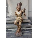 A polychrome carved 17th Century figure of 'St Sebastian' impaled with arrow holes and tethered to