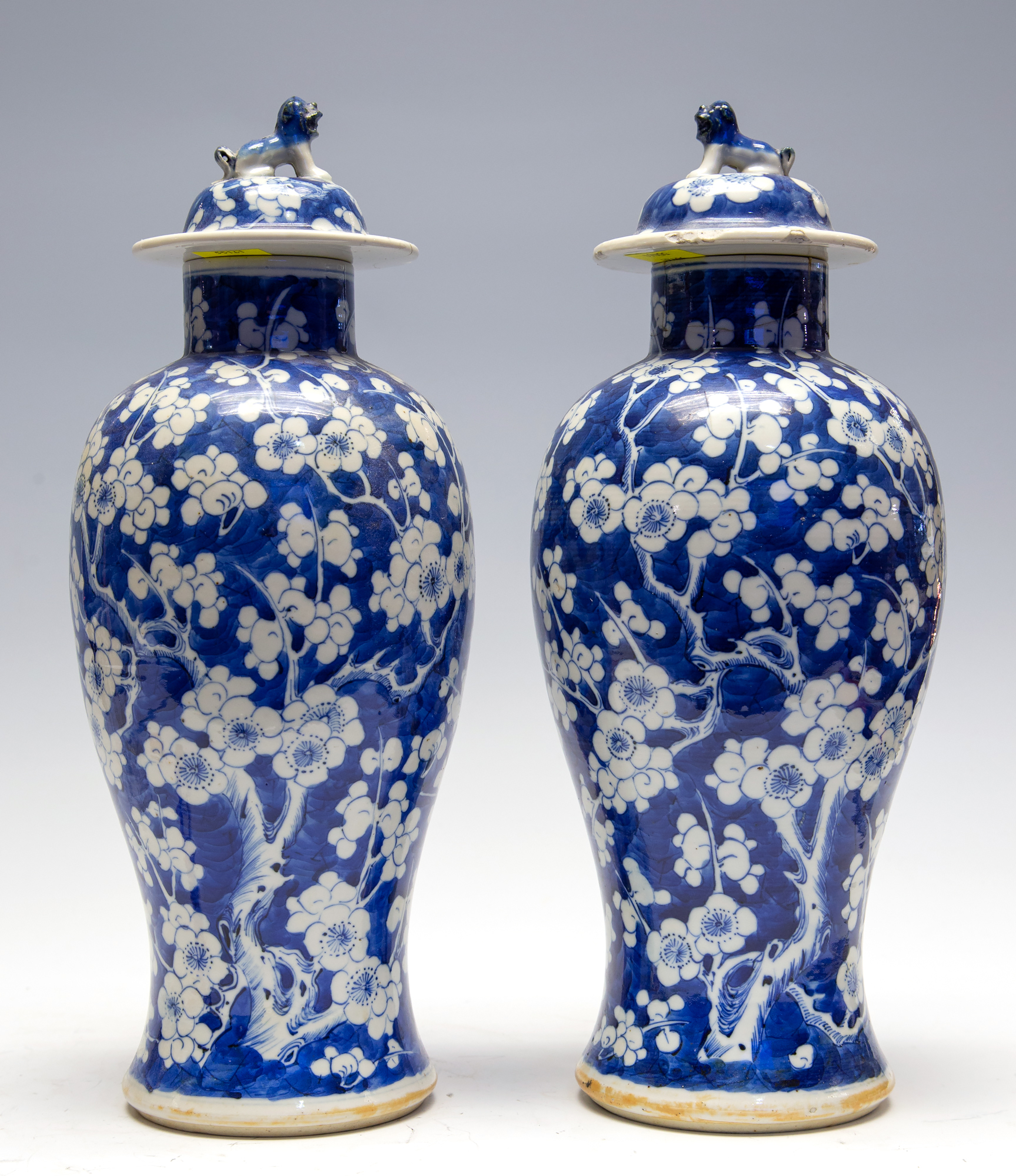 A pair of Chinese blue and white baluster vases and covers, late 19th Century with Kangxi marks,