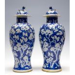 A pair of Chinese blue and white baluster vases and covers, late 19th Century with Kangxi marks,