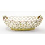 A Derby pierced oval basket, (rope handles) decorated with an apple and leaves with moths etc,