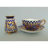 A Coalport Aesthetic tea cup and saucer, cobalt blue and gilt decorated with birds,