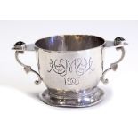 An Arts and Crafts silver twin handled cup,