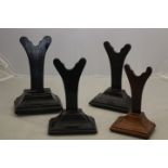 A pair of 19th Century ebonised charger stands, flared rectangular bases,