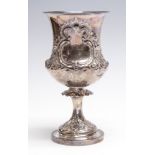 A Victorian silver ogee shaped goblet, chased with scrolling foliage and vacant cartouches,