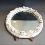 A 19th Century oval easel looking glass, the surround a Derby porcelain floral border in the white,