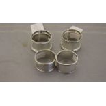 Four various silver napkin rings, comprising a pair of Walker and Hall napkin rings,