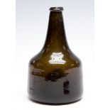 An 18th Century onion wine bottle, dark green with a kick-in base,