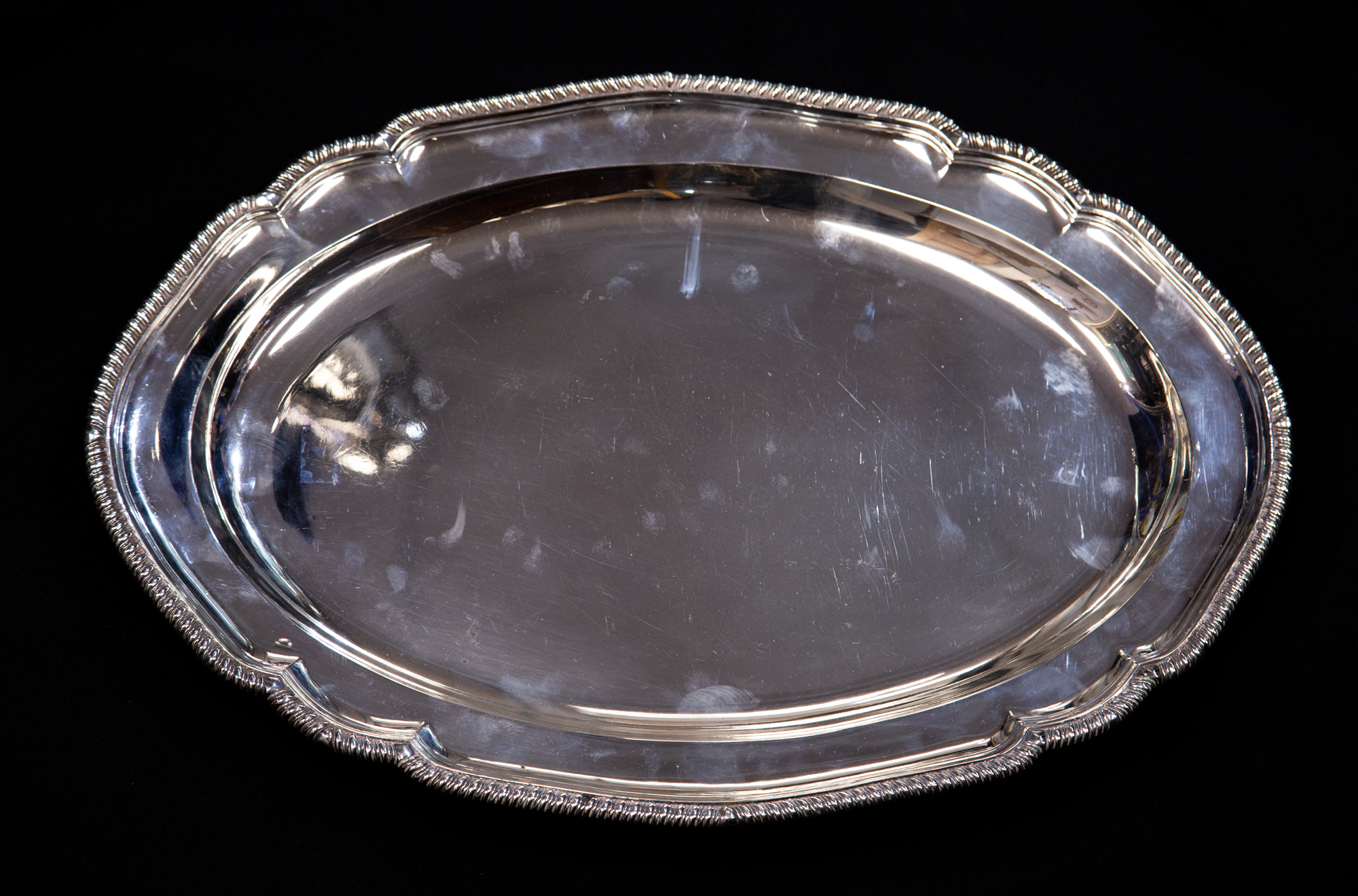 A large George III silver platter oval form with ogee gadrooned border, William Strand, London 1804,