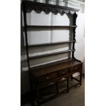 A George III oak dresser and rack, the rack with three plate shelves, the base with three drawers,