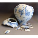 An early English delft vase, circa 1700, blue and white decoration of Chinese figures and gardens,