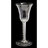 A late 18th Century wine glass, having a trumpet shaped bowl, with moulded decoration,