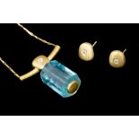 An aquamarine and diamond 18ct yellow gold pendant and earring set of designer jewellery by C.W.