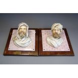 A pair of European hard paste porcelain wall plaques circa 1890 in the form of pretruding Arab