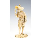 A Japanese ivory okimono of a standing fisherman wearing a rice hat and holding a fish,