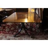 An early 19th Century mahogany twin pedestal dining table, having a removable leaf,