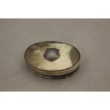 A 19th Century oval horn snuff box, applied with silver shield shape cartouche, 'W.