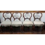 A set of six Victorian walnut balloon back chairs, each with a shaped crest rail, carved back,
