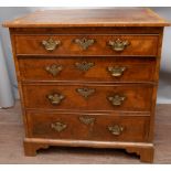 A George I walnut chest of drawers, comprising brushing slide over four drawers,