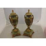 A pair of ormolu and gilt bronze pedestal vases, of Grecian design, each with acorn finials,