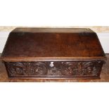 A mid 18th Century country oak writing slope, hinged top, scroll carved frieze with date 1750,