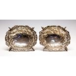 A matched pair of Victorian silver baskets, shaped oval chased with floral,