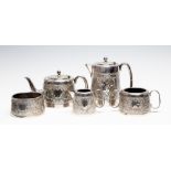 A George VI silver five piece tea service chased with with flowers and foliate band with vacant