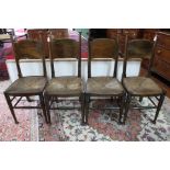 A set of six Arts and Crafts oak dining chairs, rush seats,