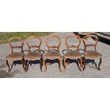 A set of five Victorian walnut balloon back chairs, overstuffed seats,