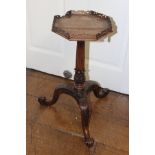 A George III style mahogany tripod kettle stand, carved throughout,
