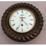 An early 20th Century circular oak cased clock, circular white enamel dial, Roman numerals,