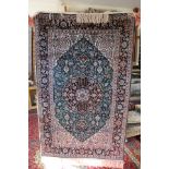 A Kashmiri 100% silk rug, having floral decoration on a green ground, No.
