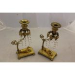 A pair of Regency gilt metal table lustres, detachable bobeches, clear fact cut glass droppers,