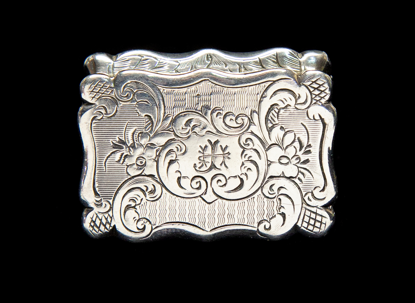 A Victorian silver vinaigrette the hinged cover engraved with scrolls and trellis, Mather,