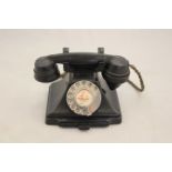 A 1950's black bakelite 200 series desk telephone, the handset dated 1957,