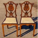 A pair of Edwardian mahogany and marquetry inlaid bedroom chairs, cartouche shaped backs,