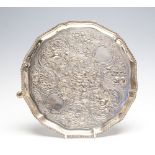 A George III silver shaped circular salver gadroon rim on three hoof feet,