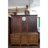 A George III oak House Keepers cupboard with clock to centre,